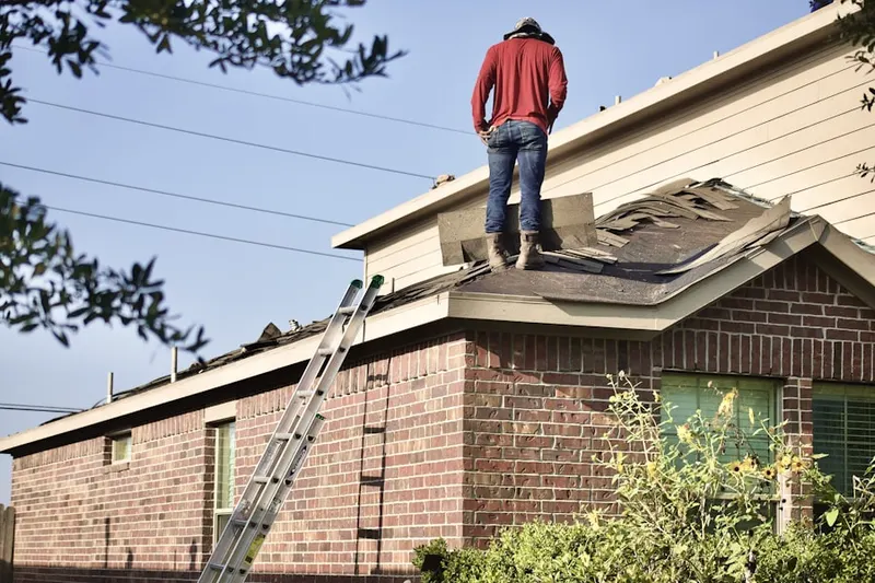 Professional roofer working on a residential roof in River Ridge